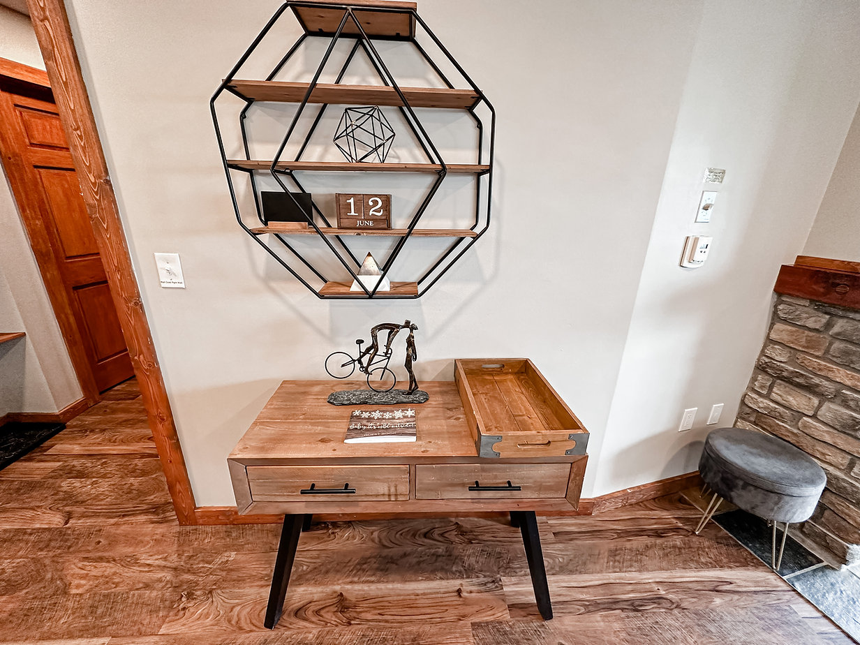 Console table and geometric shelving vignette