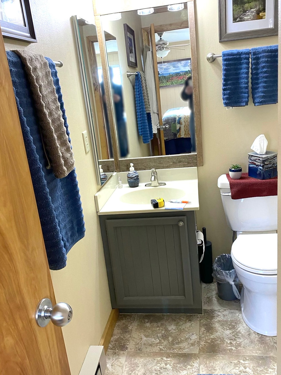 Bathroom vanity in deep green with wood mirror